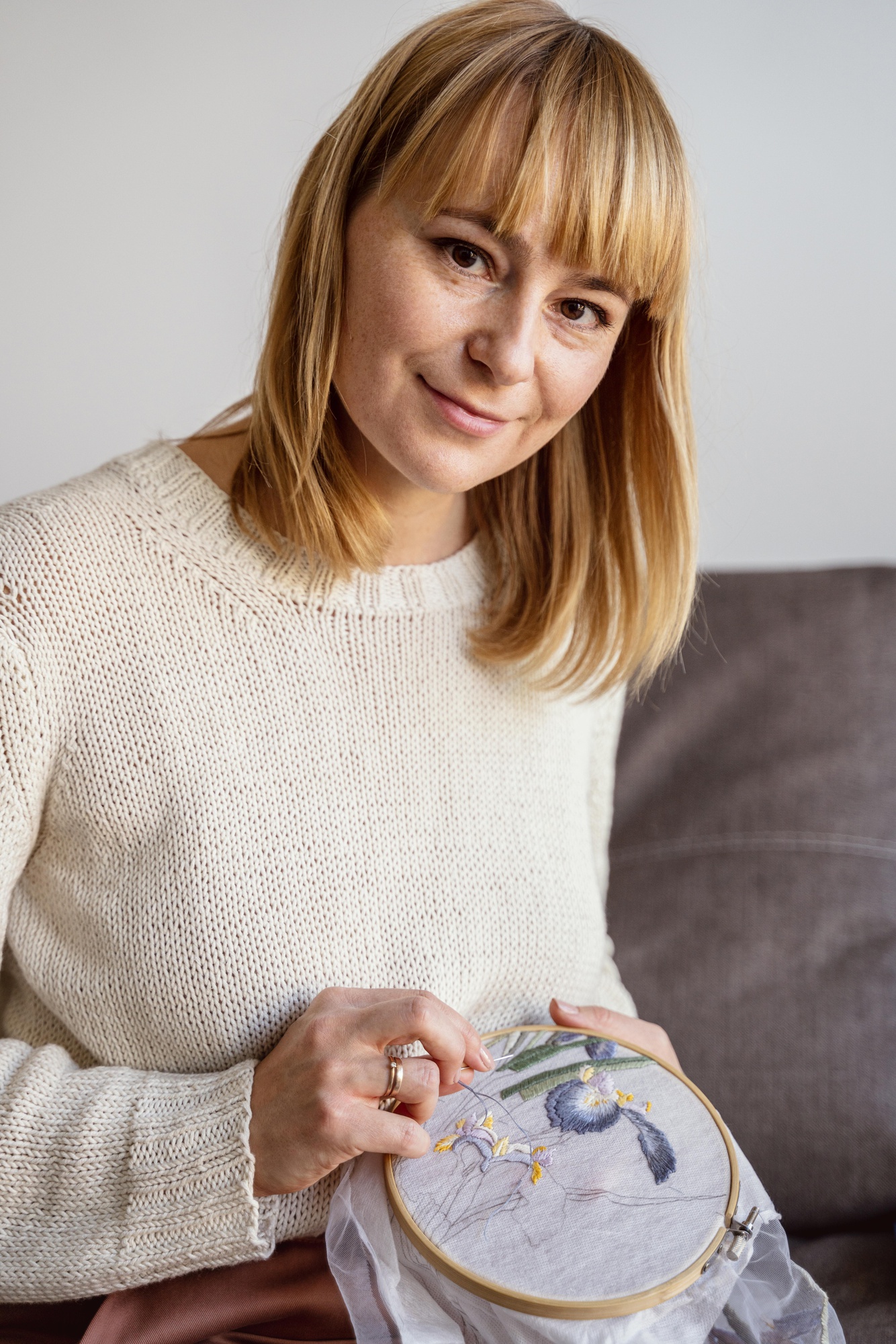 Portrait of lead instructor with embroidery hoop